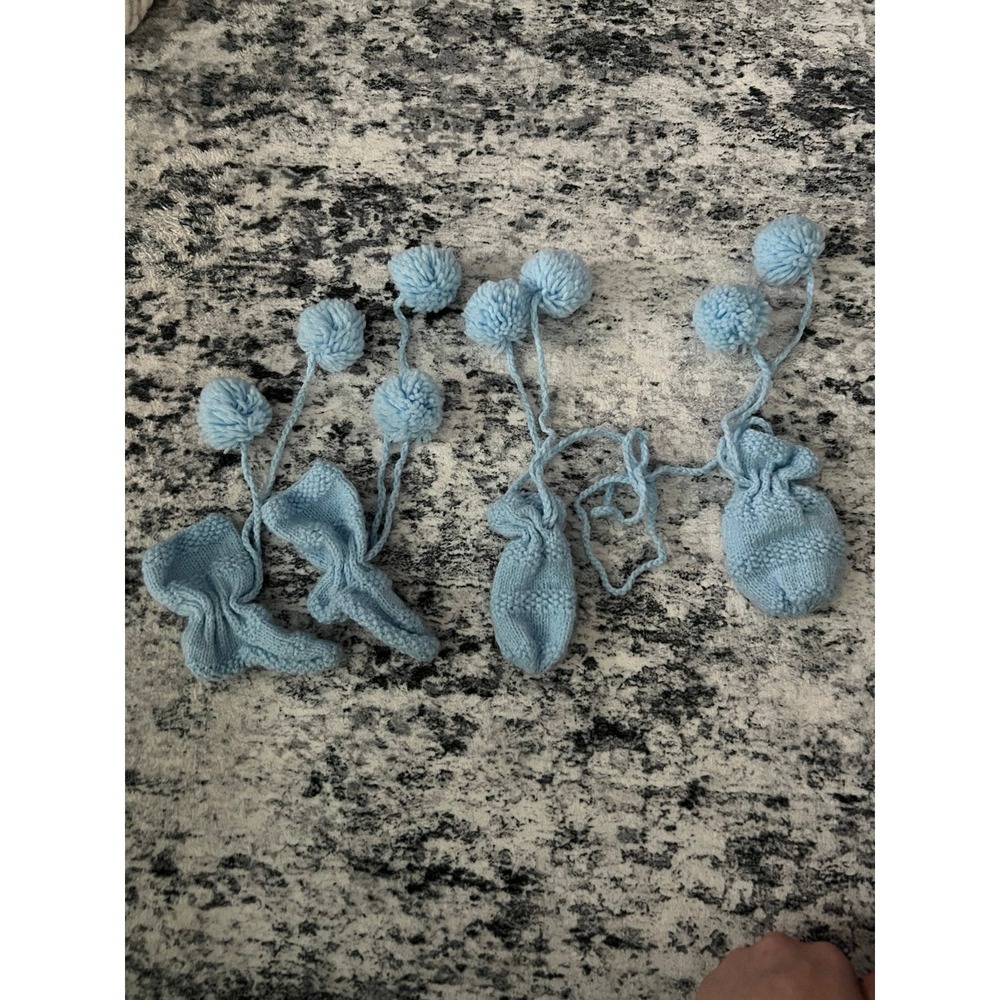 Knitted blue baby mittens and booties